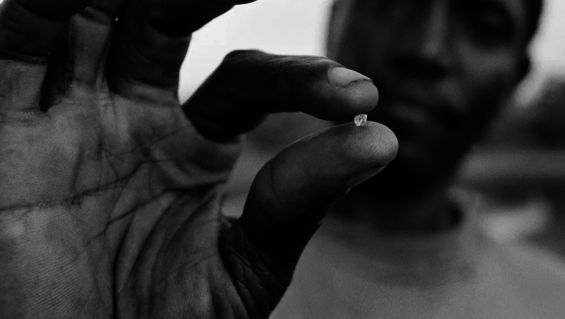 Mined rough diamond in man's hand